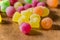 Colourful sugar sweets with licor inside on the wooden table background