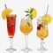 Colourful summer cocktails with fruit and straws, isolated on white background.