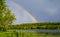 Colourful summer rainbow over an Eastern Ontario Lake after a rain storm.