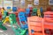 Colourful table and chairs ready for a cafe or restaurant. Summer terrace cafe, plastic colorful multi colored chairs outside. Co