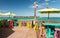 Colourful tables and chairs on a terrace along the ocean, holiday concept