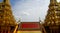 Colourful temple roof between two golden towers