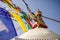 Colourful tibetan prayer flags wave in the air in the Boudhanath stupa in Kathmandu, Nepal