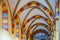 Colourful tiled arches and columns under the roof of the Imperial Cathedral of KÃ¶nigslutter