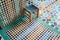Colourful tiny wooden chair on a colourful squared floor in Arabian style