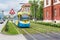 Colourful tram runs on tramway track over green grass area in Kosice SLOVAKIA, Translation = â€œTrain station square