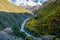 Colourful Truso Valley Gorge view vier river, forest and mountains behind in Kazbegi mountain range