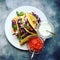 Colourful Vegetarian Mexican taco on rustic stone background top view