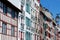 Colourful vintage facades of typical french basque homes with shutters and windows of faded colours downtown in Bayonne, Basque