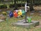 Colourful watering cans on a cemetery