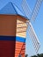 Colourful windmill in bright blue sky