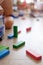 Colourful wooden toy bricks on an interior hardwood floor