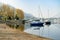 Colourful yachts docked at marina of Lecco town on spring day. Picturesque waterfront of Lecco located between famous Lake Como