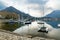 Colourful yachts docked at marina of Lecco town on spring day. Picturesque waterfront of Lecco located between famous Lake Como