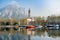 Colourful yachts docked at marina of Lecco town on spring day. Picturesque waterfront of Lecco located between famous Lake Como