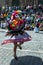 A colourfully dressed lady performs down a Cusco street during the May Day parade in Peru.