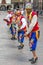 Colourfully dressed men perform down a Cusco street during the May Day parade in Peru.