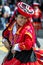 A colourfully dressed performer dances down a Cusco street during the May Day parade in Peru.