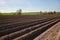 Colours of spring - ploughed field ready to sow. Agricultural fields in Russia.