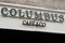 Columbus Cafe & Co logo and text sign front of French facade coffee and fastfood
