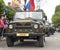 Column of military cars with veterans onboard on parade in honor