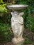 Column of pedestal font. Classic stone garden statue / sculpture.