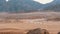 Column of a quad bike rides through the desert in Egypt on backdrop of mountains. Driving ATVs.