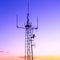 Column with radio transmitter against sunset colors sky
