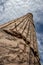 The column of a Roman temple taken from below, with the sky clouded over in the background