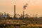 Column of smoke rising from tall white smokestack