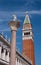 The column of St. Theodore and the bell tower of St. Mark-Campanile-in the center of Venice. In the background, the