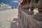 Columns of concrete fencing along the road near a park during a hail with rain