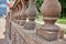 Columns of concrete fencing along the street near the park