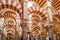 Columns and double-tiered arches in the interior of the Mosque-Cathedral of Cordoba, Spain