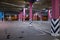 Columns in an empty underground parking at night in the light of artificial lighting. City infrastructure