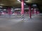 Columns in an empty underground parking at night in the light of artificial lighting. City infrastructure