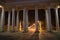 Columns in front of the entrance. Autumn night landscape in the park alley trees