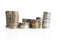 Columns of silver and gold coins on a white background. The concept of inflation.