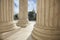 Columns of the Supreme Court with an American flag and the US Ca