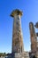 Columns towering up into a blue sky at archeological site at ancient Corinth Greece