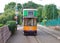 COLYTON, DEVON, ENGLAND - AUGUST 6TH 2012: An orange and green tram sits empty in Colyford station on the Seaton tramway