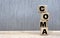 COMA word on cubes on a beautiful gray background