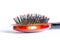 Comb hair with tufts, bundle of hair, lots of hair on the hairbrush close up on a white