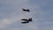 Combat aircraft in formation with two turboprop tandem training planes