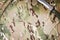 Combat knife on military camouflage fabric background