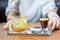 A combination between fresh Coffee, Lemon, Orange Soda on the stainless plate on wood table in front of blur woman in Coffee cafe