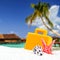 Combination of sandy and suitcase front with blurred tropical island