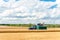 Combine cutting wheat on the field. Harvest time.