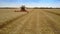 Combine gathers rich golden rye harvest in wide field