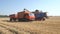 Combine grain pours into the truck-trailer.